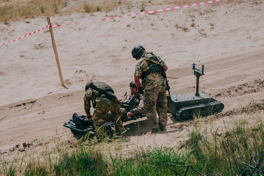 Soldiers perform a simulated evacuation using a ground drone in the Kyiv region in Ukraine.