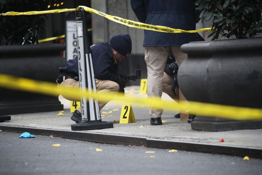 Police investigate outside Hilton Hotel in Midtown Manhattan, where UnitedHealthcare CEO Brian Thompson was fatally shot on December 4, 2024.