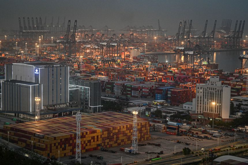 Shipping containers and gantry cranes at the Yantian port at night in Shenzhen, China, on April 14, 2025.