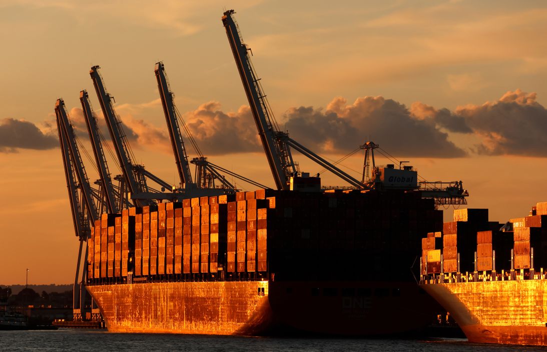 Container ships are unloaded at Port Liberty as the sun sets on September 1 in Bayonne, New Jersey.