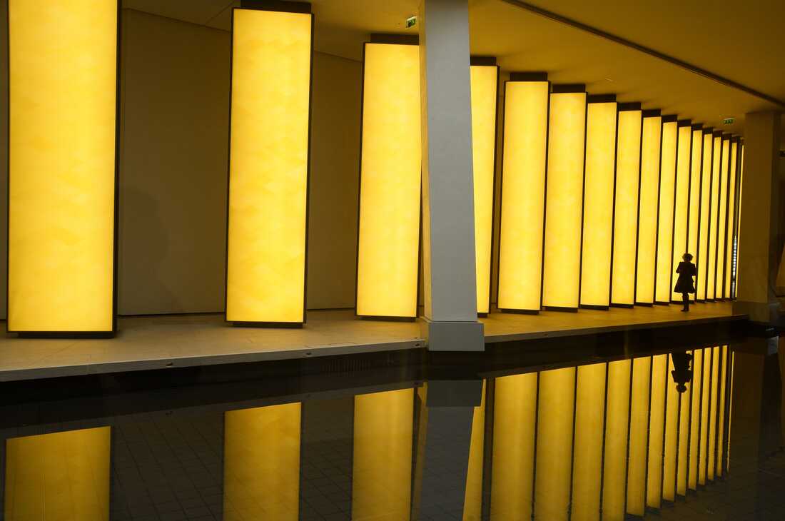 A woman walks inside the Louis Vuitton Foundation in the Bois de Boulogne in Paris.