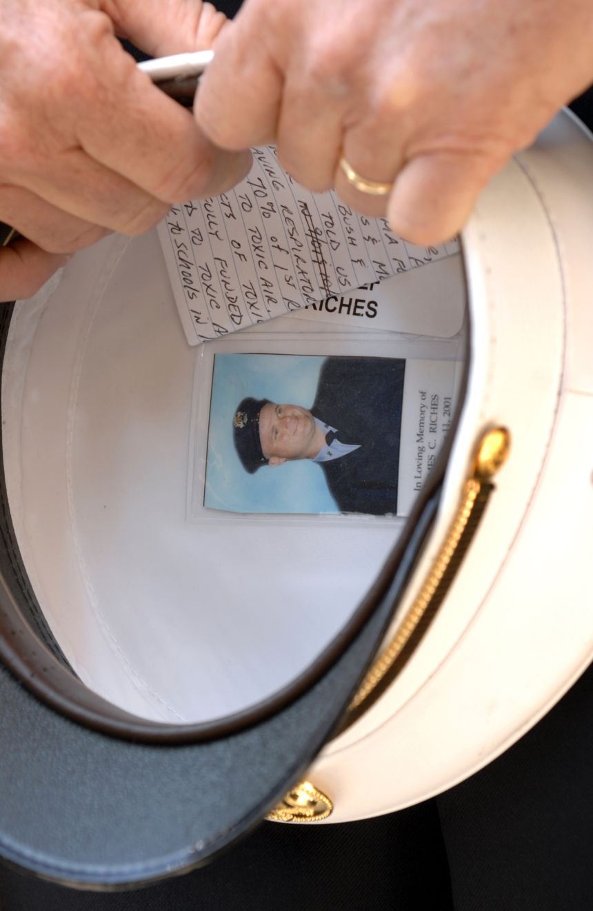 FDNY Deputy Chief James Riches holds his hat, which contains a picture of his son, Jimmy Jr., an FDNY firefighter whom he found in the rubble of the World Trade Center on March 25, 2002.