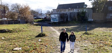Tim Toffolo and Silva Leone walk through the area in downtown St. Catharines, Ont., that they cleared of trash and drug paraphernalia.
