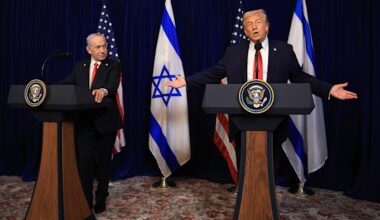 Benjamin Netanyahu, left, and Donald Trump stand at podiums during a press conference, with US and Israeli flags behind them.