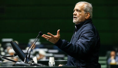 Masoud Pezeshkian gestures while speaking at a podium during a session to submit Iran’s draft budget bill to parliament.