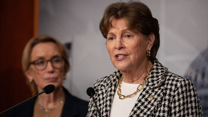 Sen. Jeanne Shaheen speaks at a press conference, with another woman standing in the background.