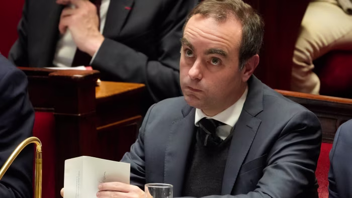 Sébastien Lecornu sits in the National Assembly, looking attentive during a parliamentary vote.