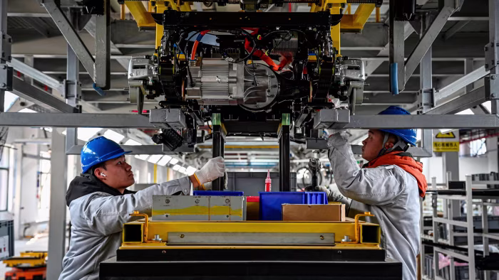 Employees work on autonomous vehicle production line at a factory in China’s eastern Jiangsu province