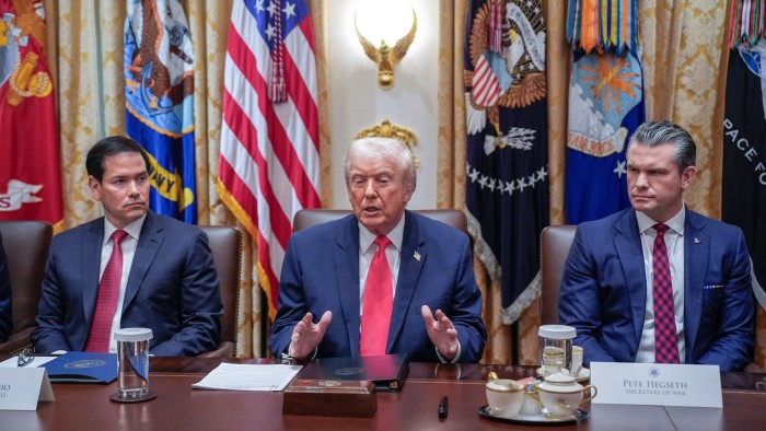 US President Donald J. Trump speaks at a Cabinet meeting, seated between Marco Rubio and Pete Hegseth in the Cabinet Room.