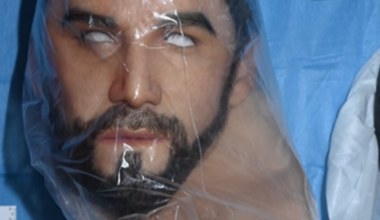 Man charged with 60 offences after police discover multiple weapons, including grenades and loaded guns, in container in Revesby