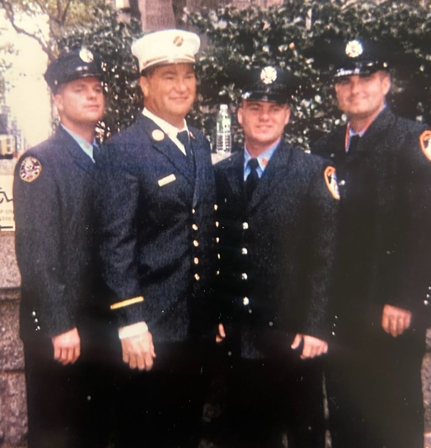 FDNY Deputy Chief James Riches, center, with his three surviving sons. From left, Timmy Riches, Thomas Riches and Danny Riches.