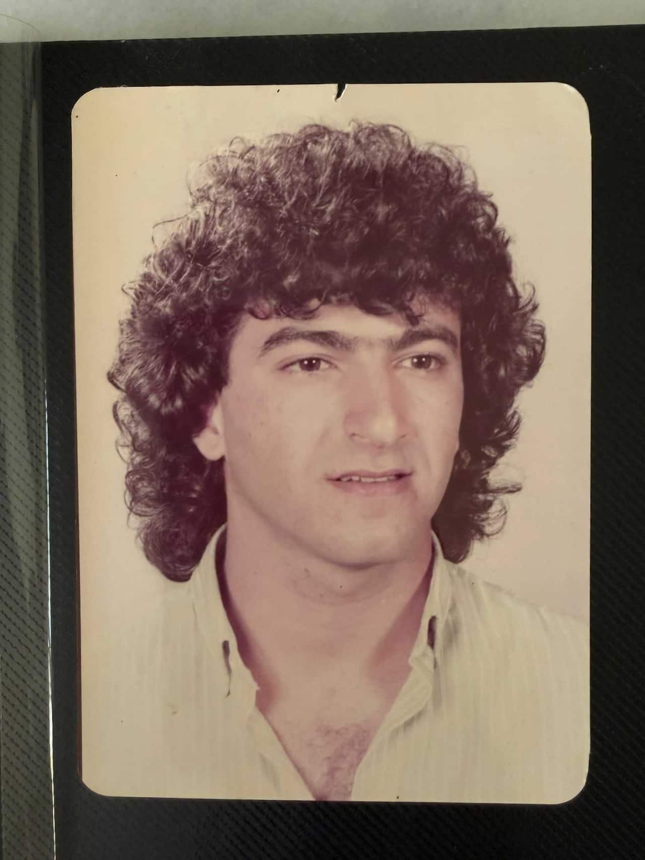 An old photo of a man in a white shirt