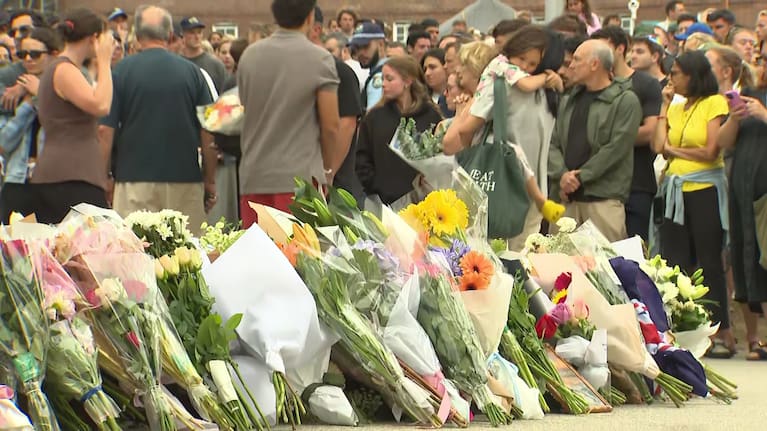 Mourners gather at a vigil for the victims of the Bondi beach shooting yesterday. 