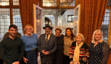 Menorah lit on Guildford balcony as a symbol of pluralism and religious liberty in a town