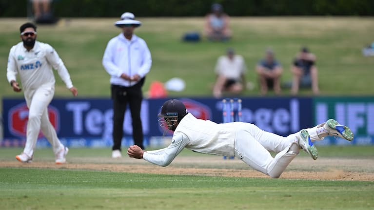 Rachin Ravindra dives to catch Kavem Hodge off Ajaz Patel's bowling at Bay Oval.
