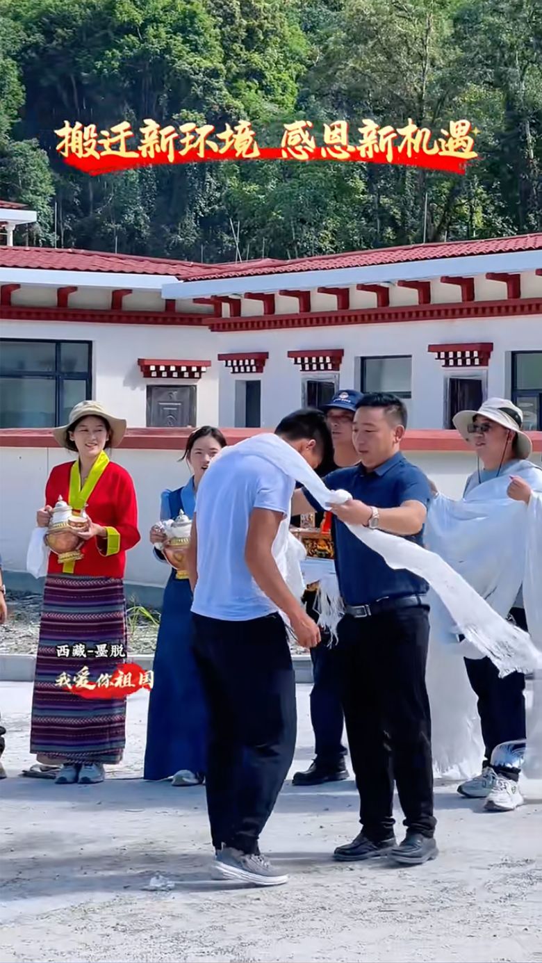 Villagers are welcomed with Tibetan ceremonial scarves upon their arrival at their new abode.