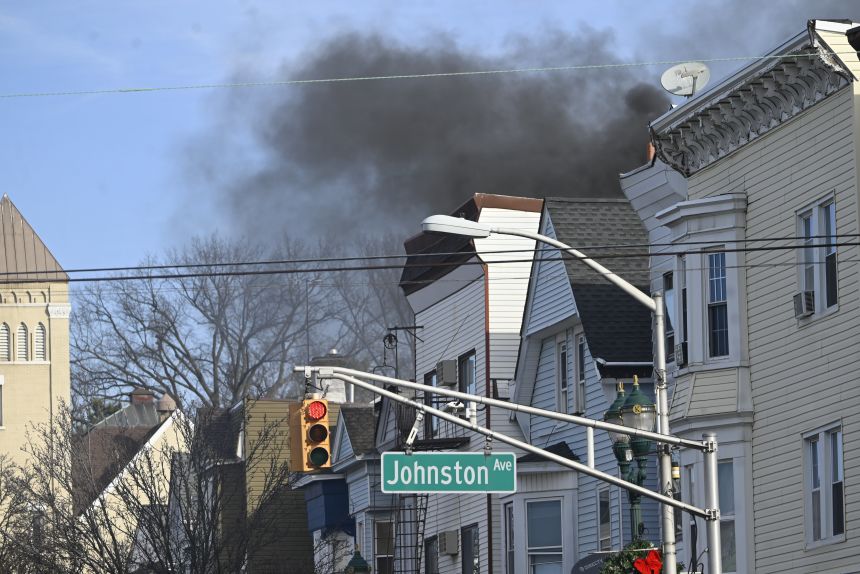 Smoke billows from a home where a suspect reportedly barricaded himself after allegedly killing a man with a bow and arrow in Kearny, New Jersey, on December 21.