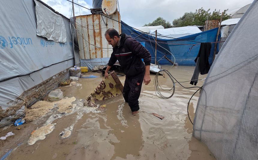 Displaced Palestinians, staying in makeshift tents, struggle to survive in water-logged tents as rain and severe storms affect the Al-Mawasi area, west of Khan Younis, in the southern Gaza Strip, on Sunday.