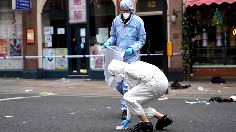 Forensic investigators collect evidence at the scene. File pic: PA
