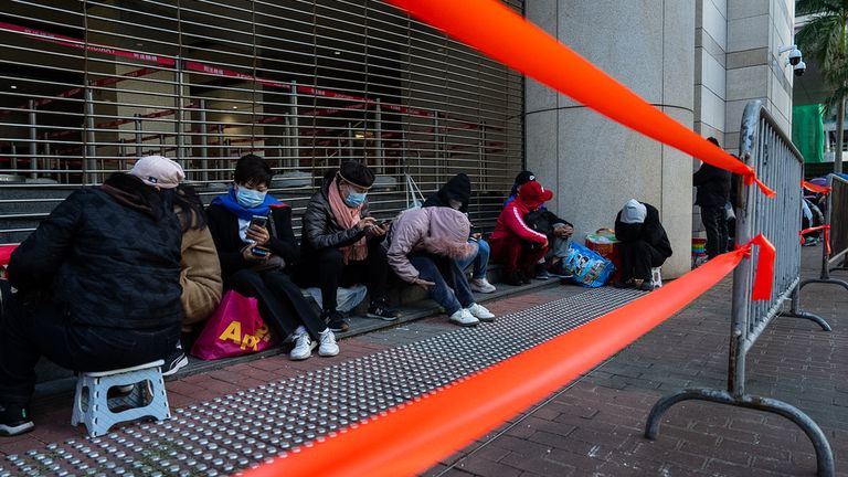 People wait to enter the building ahead of the verdict. Pic: AP