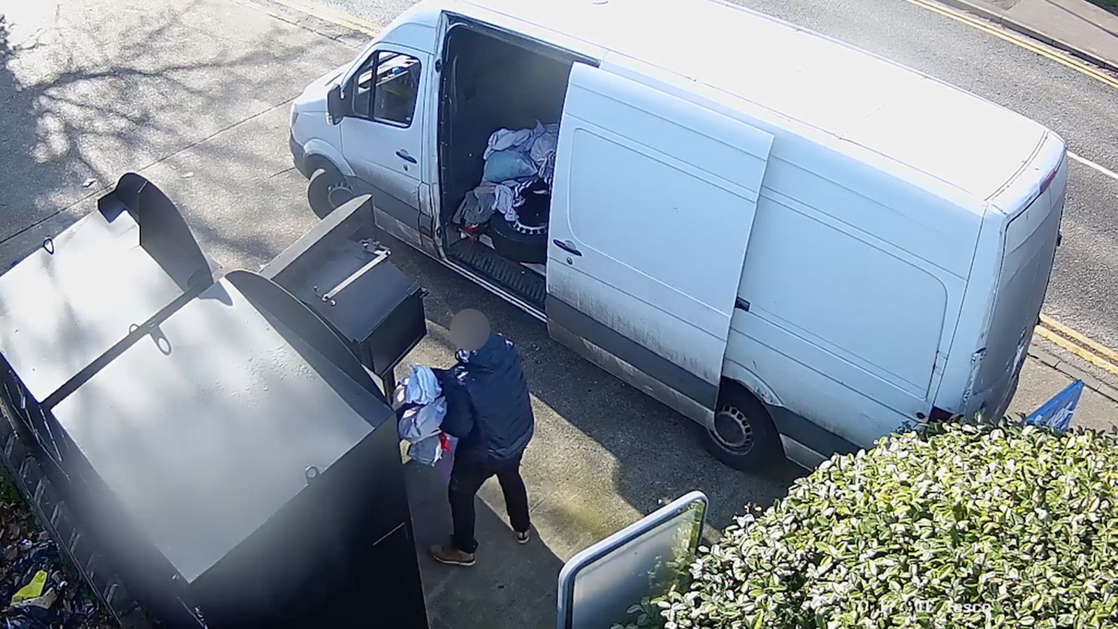 Suspects were pictured stealing charity donations and loading them into vans. Pic: PA
