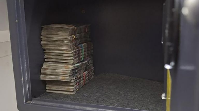 £10,000 was found in a safe in one property. Pic: PA