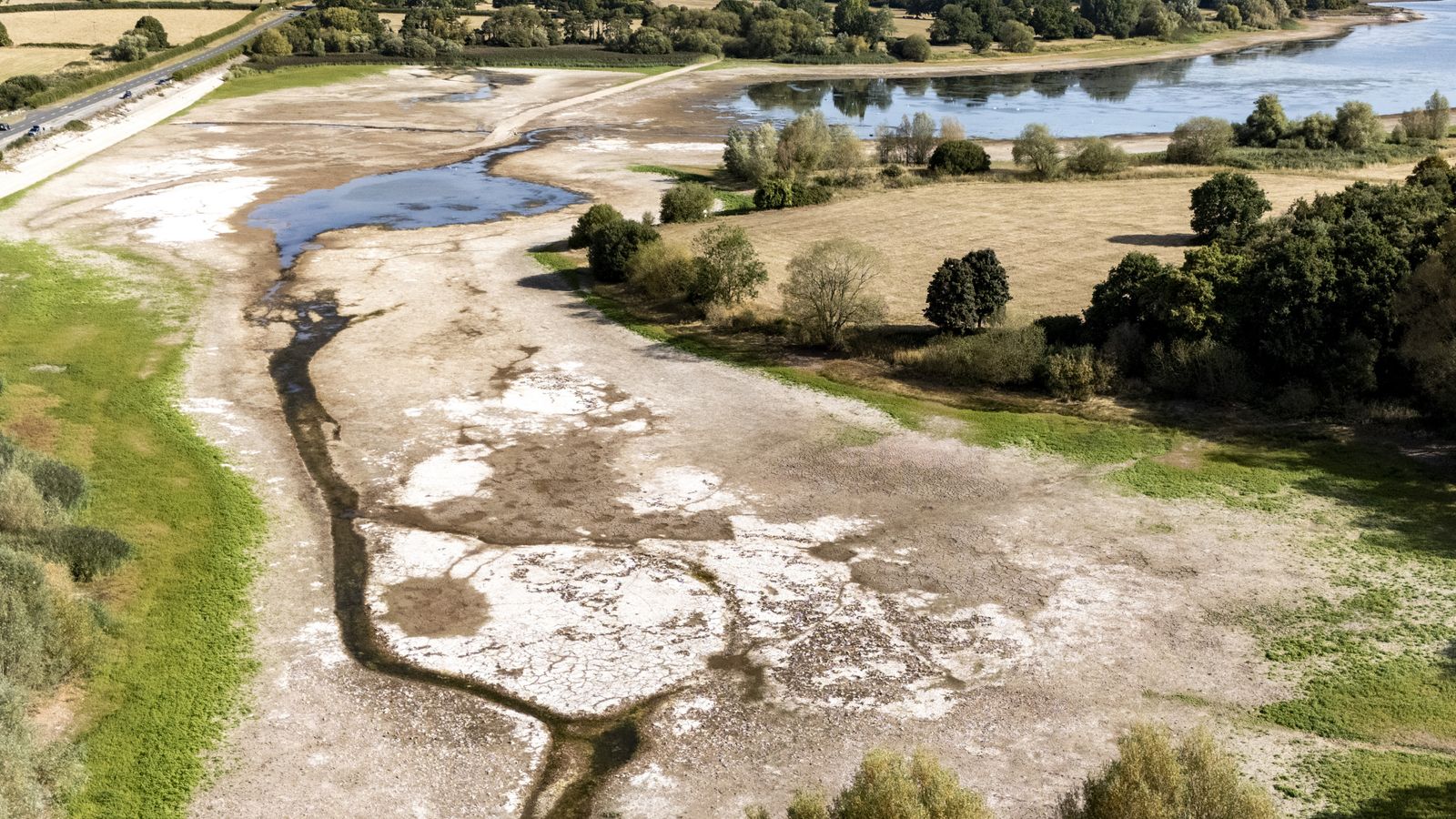 A parched lake bed is exposed in North Somerset in August. Pic: PA