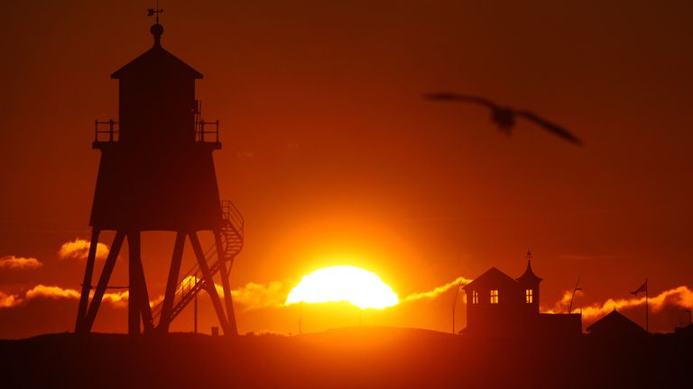 New Year's Eve sunrise over the Herd Groyne Lighthouse in South Shields. Pic: PA