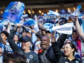 Fans wave flags and towels before the Vancouver Whitecaps and Los Angeles FC play the MLS Western Conference semifinal playoff soccer match at B.C. Place on Saturday, November 22, 2025.