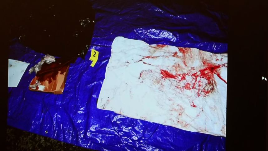 An image of items recovered from a dumpster shows one of two white towels with 