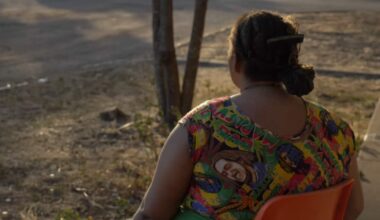 A shot of a woman wearing a colourful dress, taken from behind.