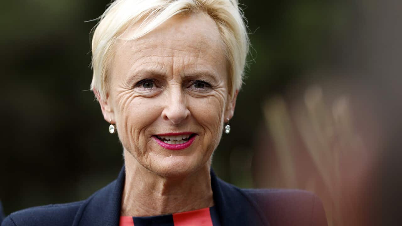 A middle-aged white woman with short blonde hair