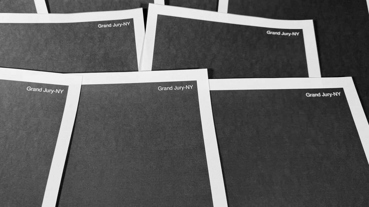 A pile of papers, which have been completely redacted with black boxes.