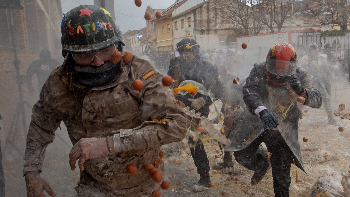 Photos show flour, eggs and firecrackers flying at Spain's Els Enfarinats festival