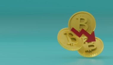 A picture of three Bitcoin tokens with an arrow on them pointing down.