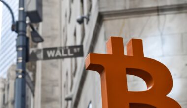 A red Bitcoin logo on Wall Street, outside the NYSE building.