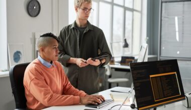 Two people looking at a computer.