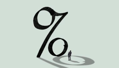 A person looking up at a large percent sign.