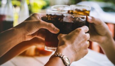 Friends make a toast with soda glasses.
