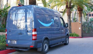 A blue Amazon van on the street.