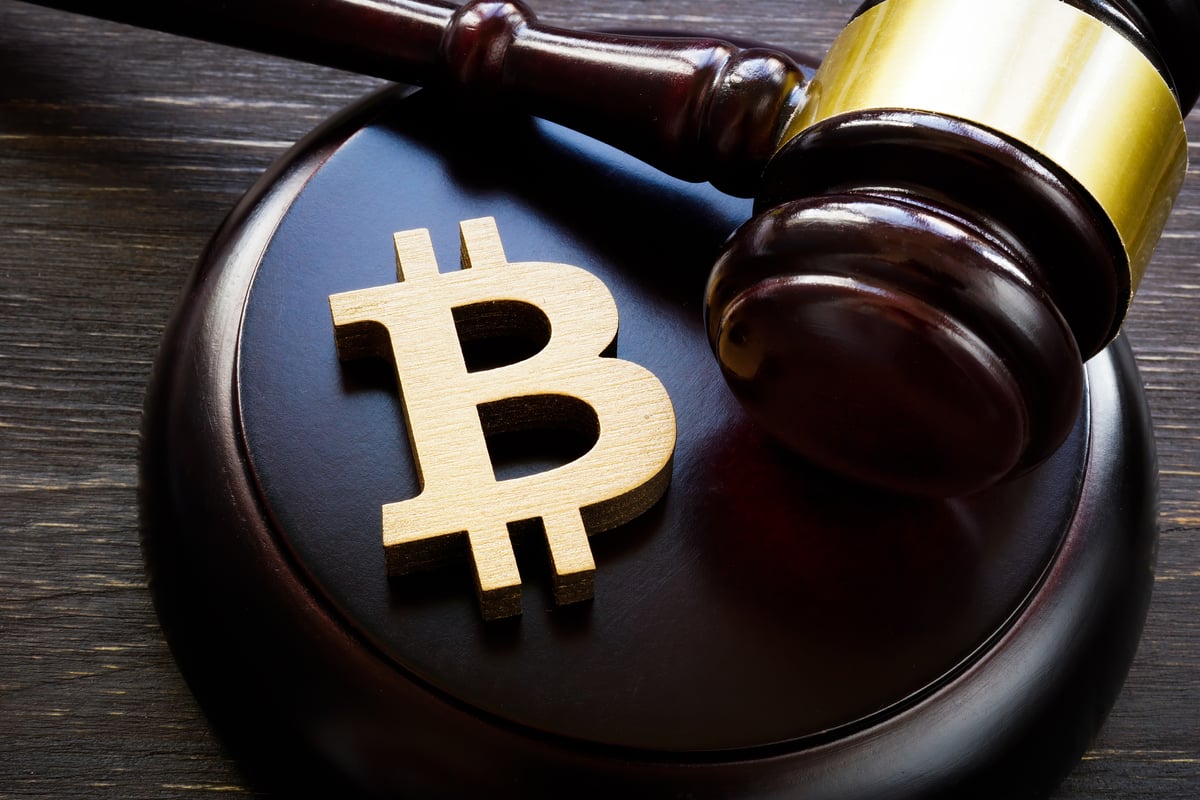 The Bitcoin symbol with a gavel next to it.
