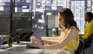 A person working at a desk with two monitors.