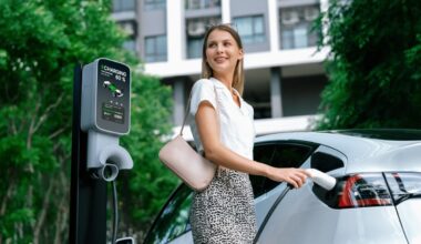 A woman charges her electric car.