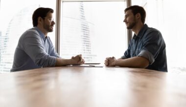 Two people sitting across from one another.