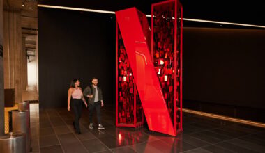 People walking around a large, red Netflix logo.