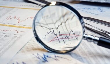 A magnifying glass hovers over stock price charts on newsprint.