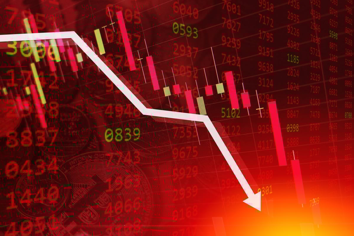 A charting arrow trending downward on a bright red backdrop.