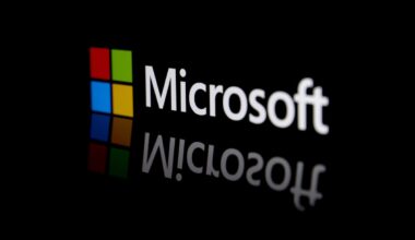 The Microsoft logo and name on a black background and reflection