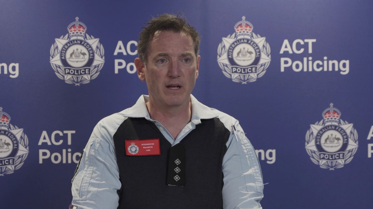 An ACT Policing officer addressing the media