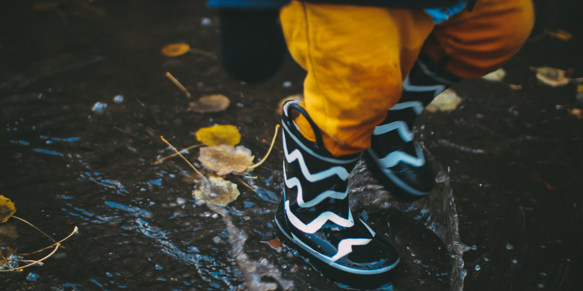 Wellies splashing in the rain. Photo Daiga Ellaby